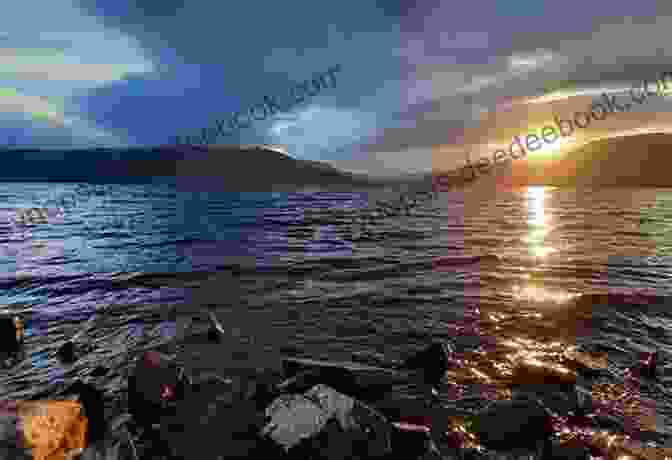 Sunset Over Loch Ness, Casting A Warm Glow Over The Lake And Surrounding Hills. The Lake: Lake Ness Beyond The Mountain